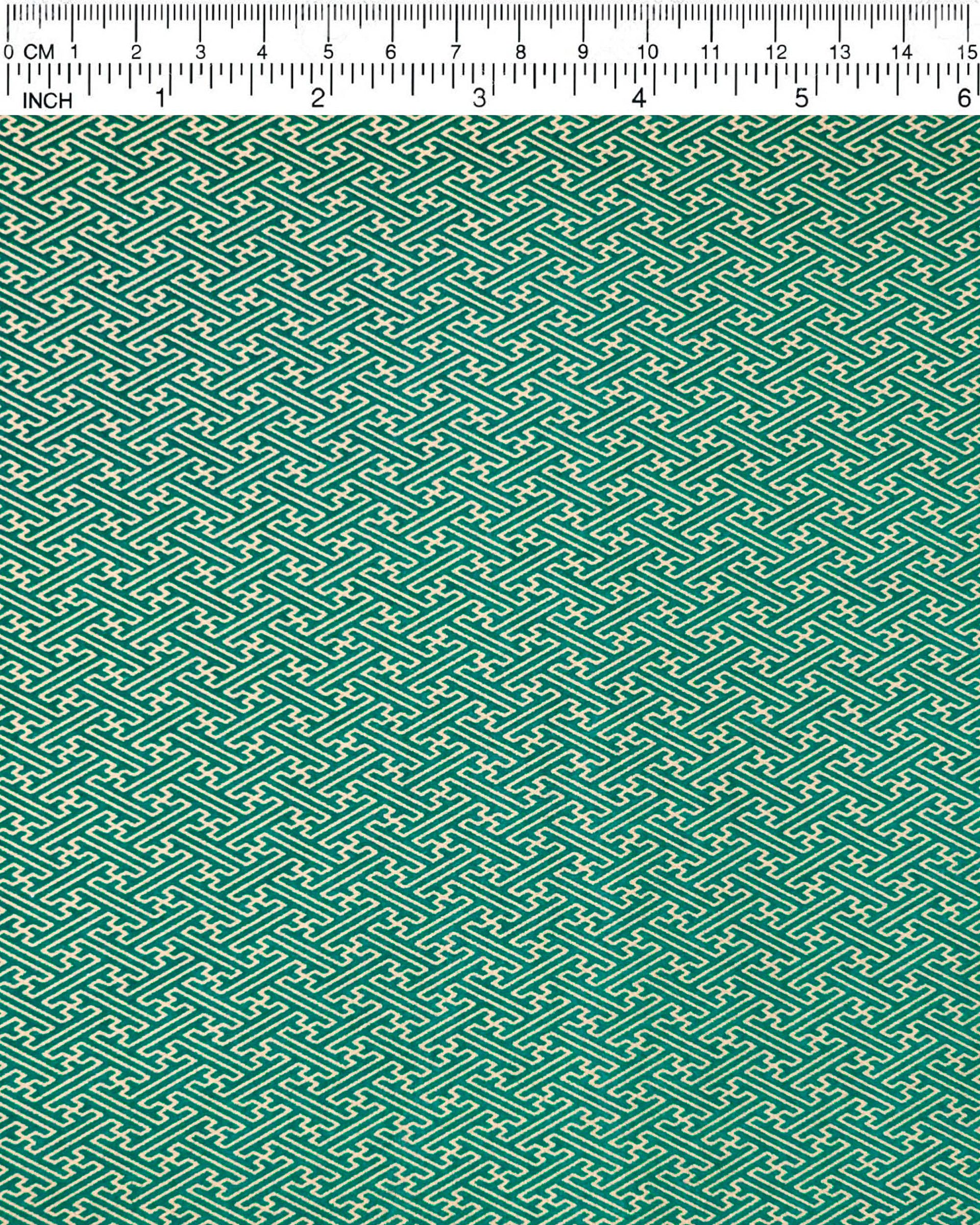 Japanese chiyogami paper featuring a small metallic gold traditional Japanese sayagata design on a green background.