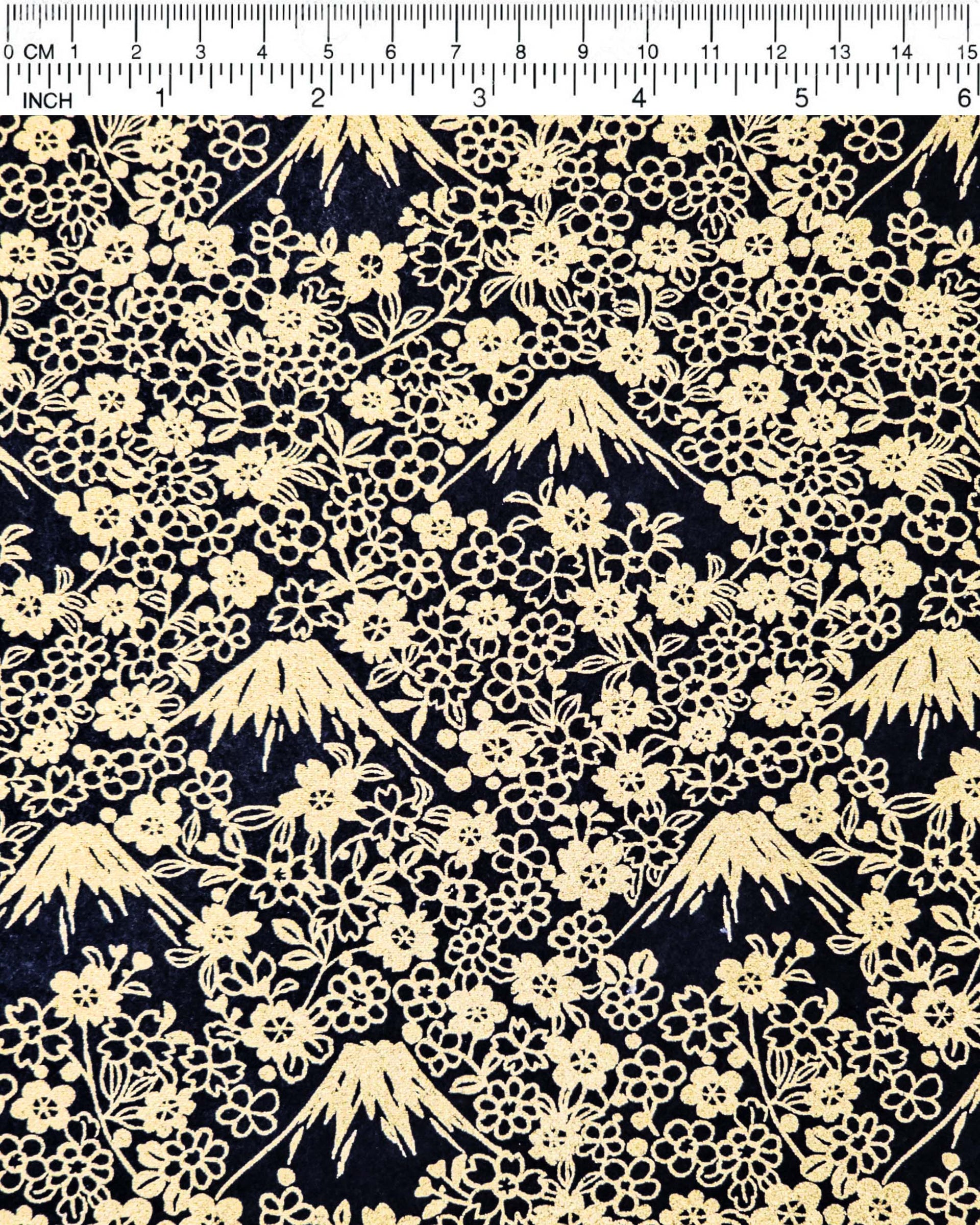 Japanese chiyogami paper featuring metallic gold Mt Fuji and cherry blossoms on a black background.