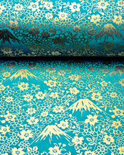 Japanese chiyogami paper featuring metallic gold Mt Fuji and cherry blossoms on a teal blue background.