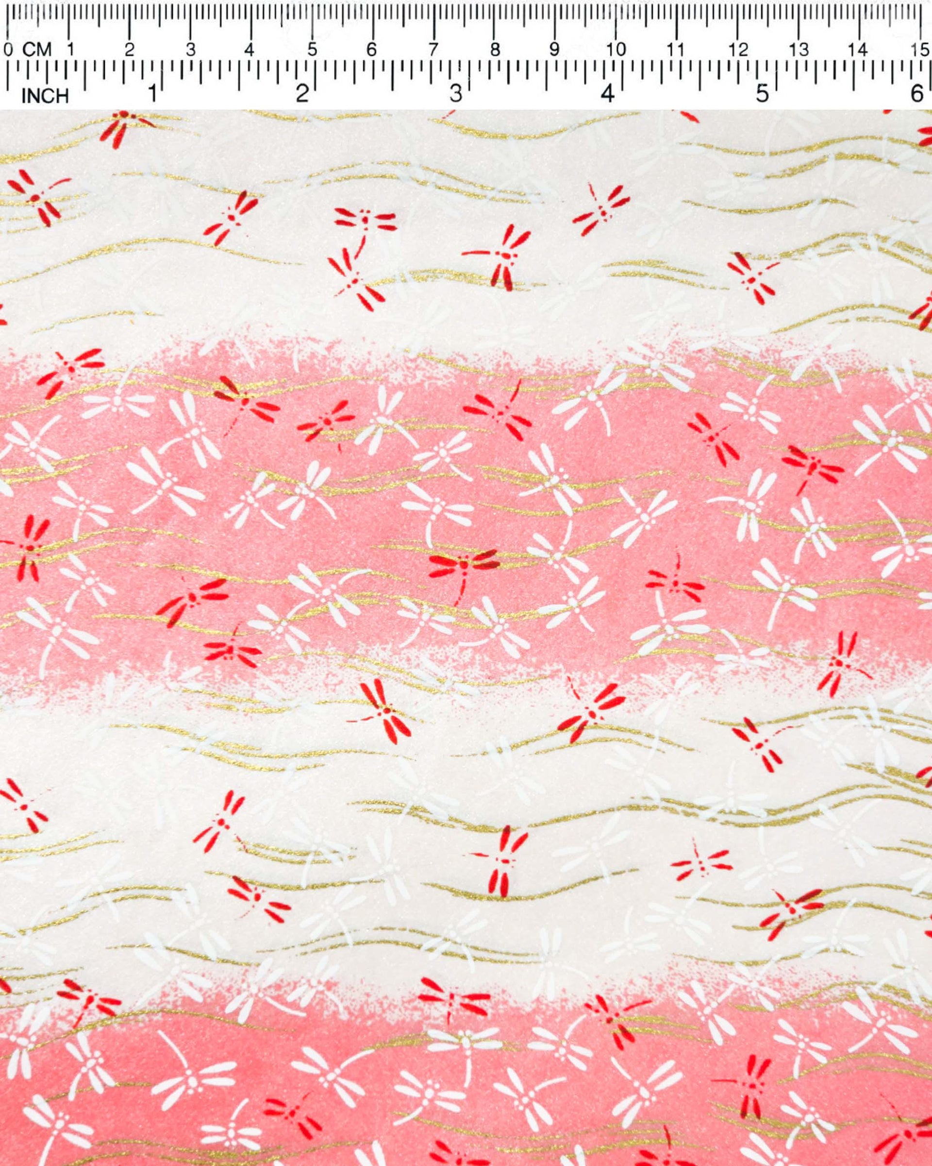 Japanese chiyogami paper featuring pink and white dragonflies on a pearlescent pink and white striped background with metallic gold wavy lines.