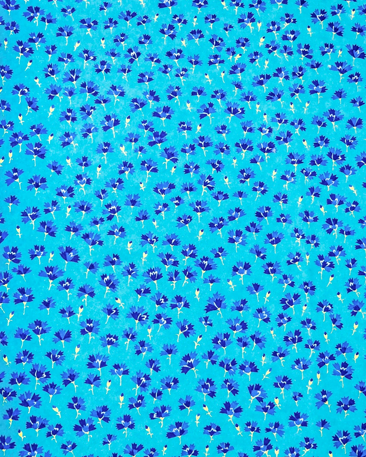 Japanese chiyogami paper featuring small dark blue flowers with metallic gold stems on a blue background.