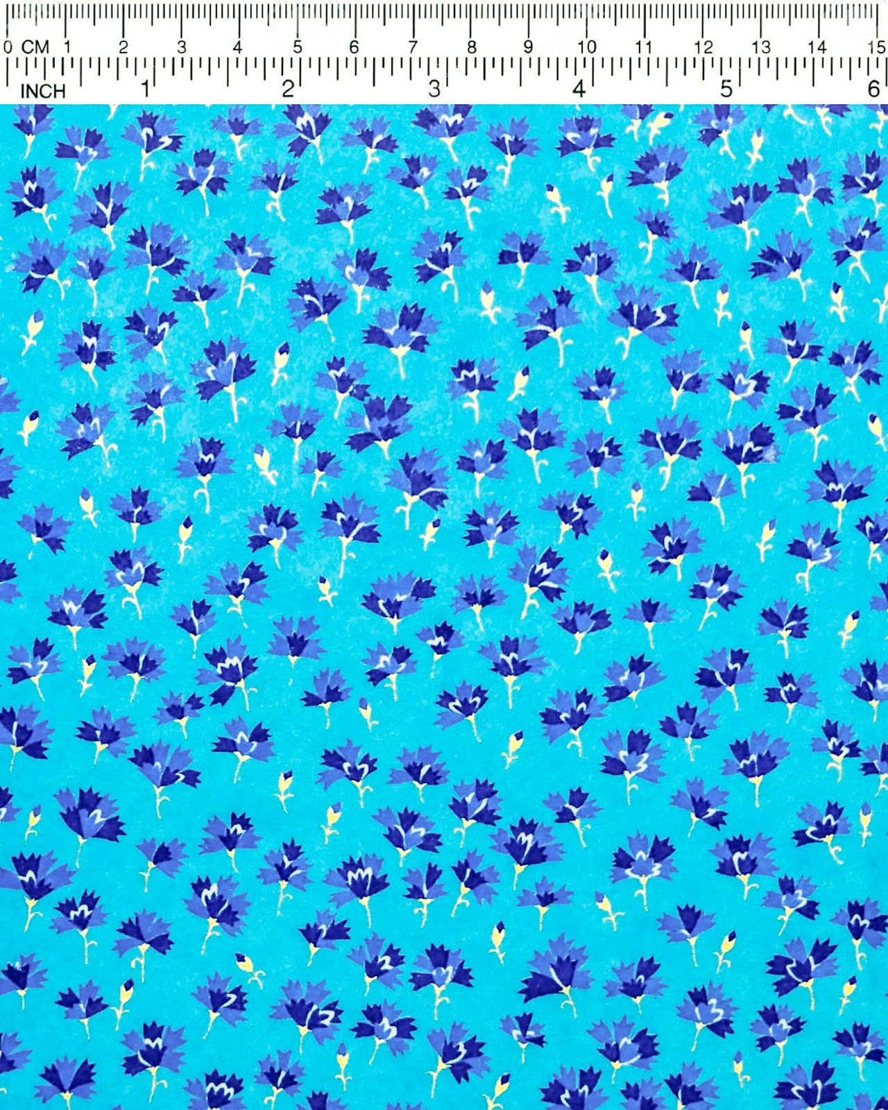 Japanese chiyogami paper featuring small dark blue flowers with metallic gold stems on a blue background.