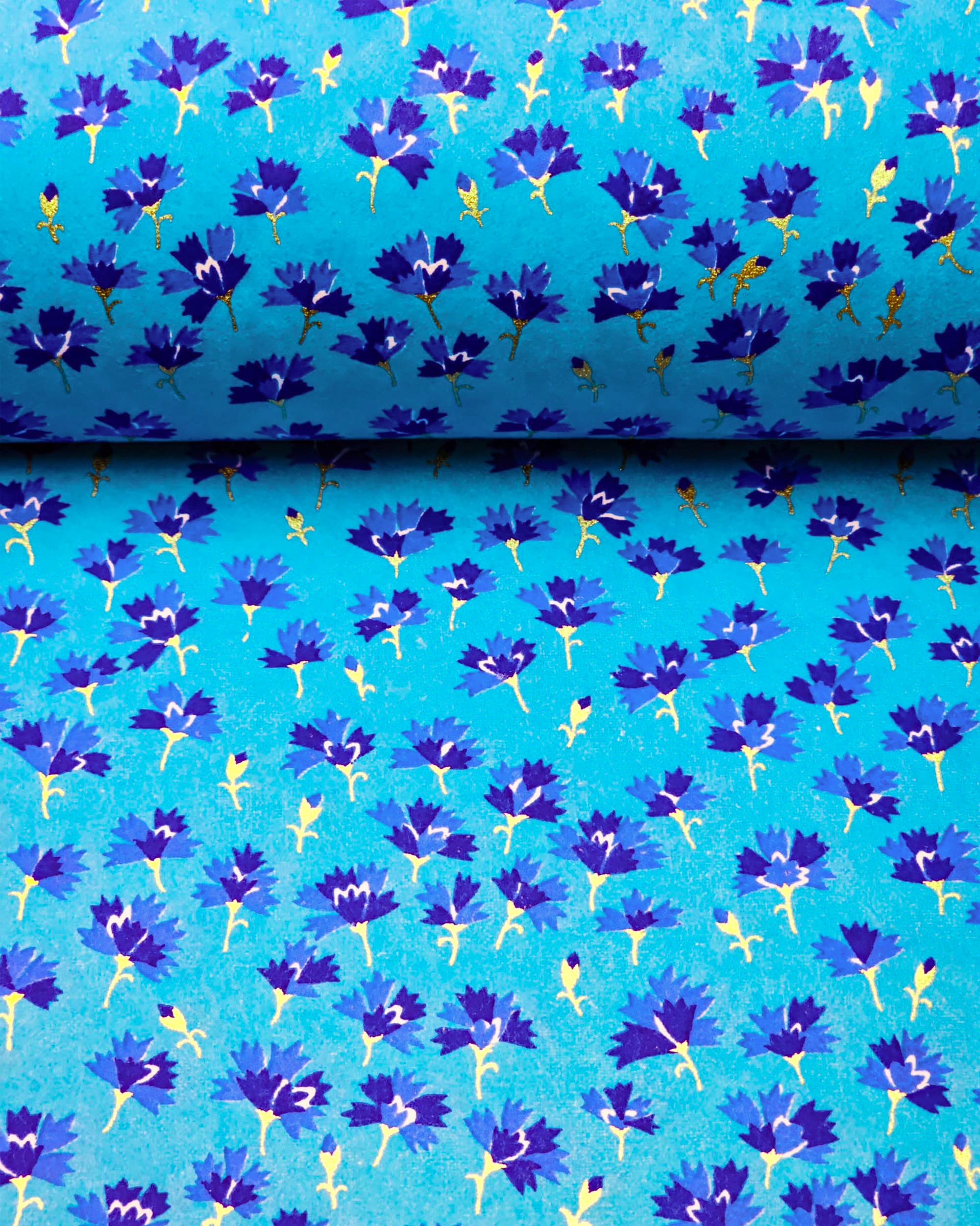 Japanese chiyogami paper featuring small dark blue flowers with metallic gold stems on a blue background.