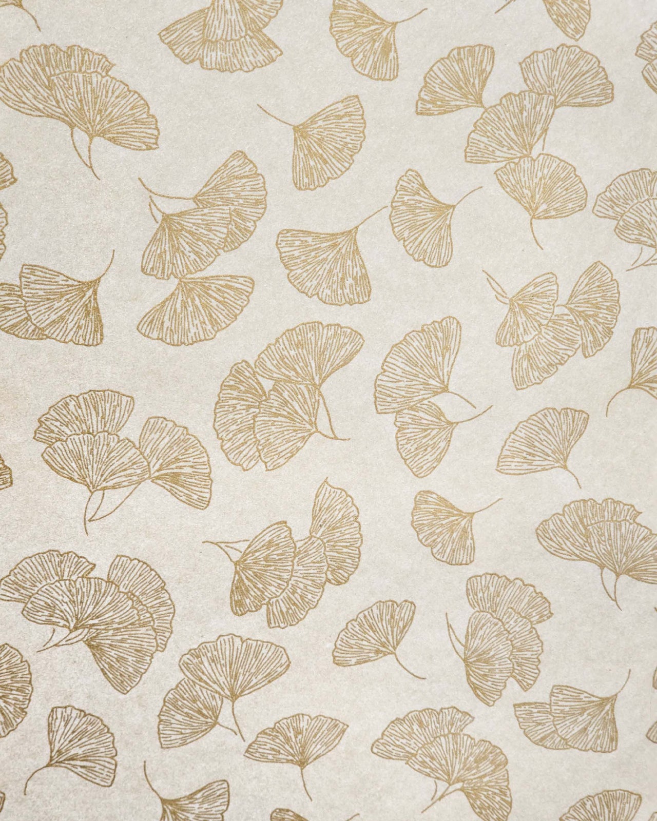 Japanese chiyogami paper featuring large metallic gold gingko leaves on a light shimmering gold background.