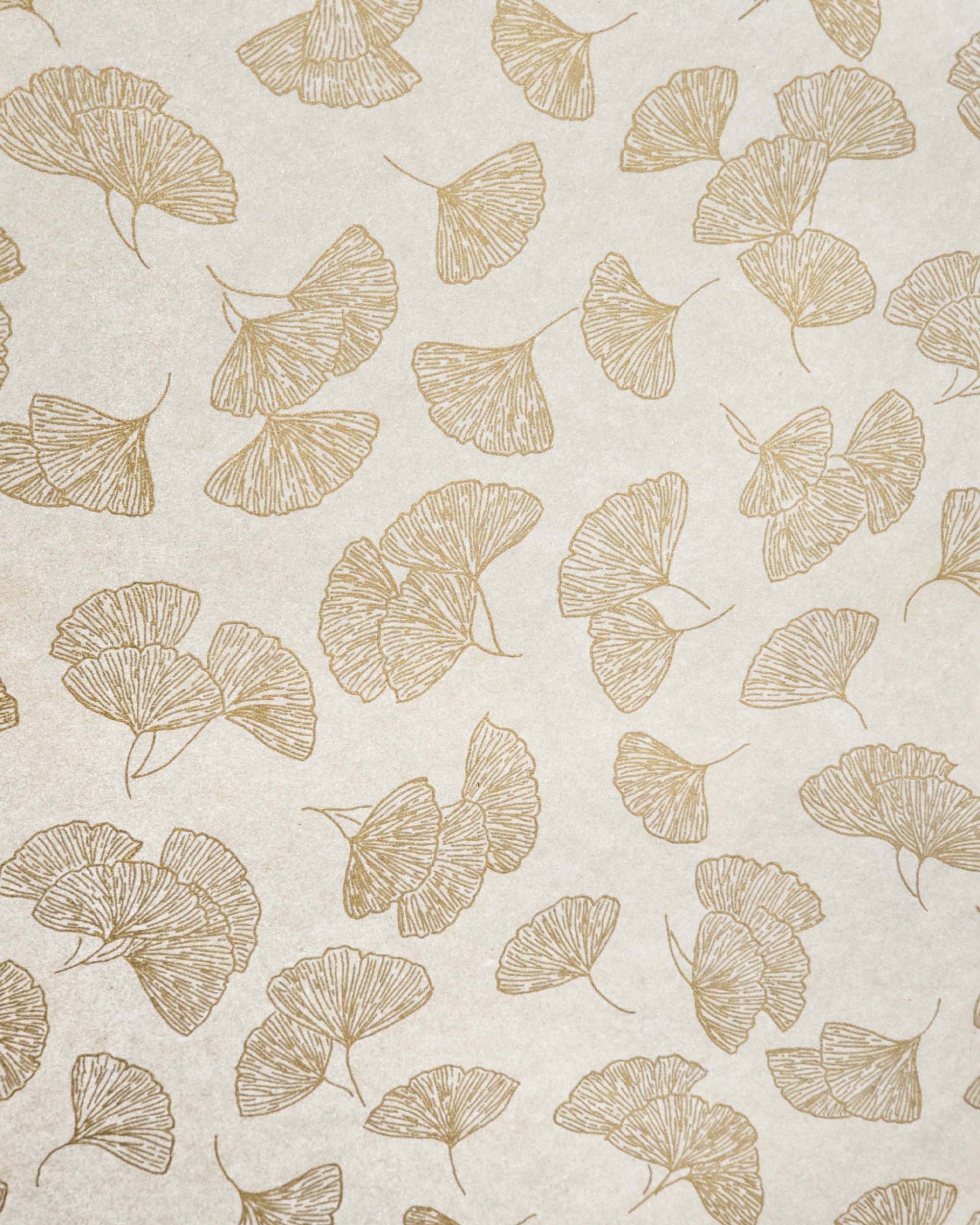 Japanese chiyogami paper featuring large metallic gold gingko leaves on a light shimmering gold background.