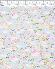 Japanese chiyogami paper featuring white origami cranes with green plants and pink plum blossoms on a light blue background with metallic gold details.