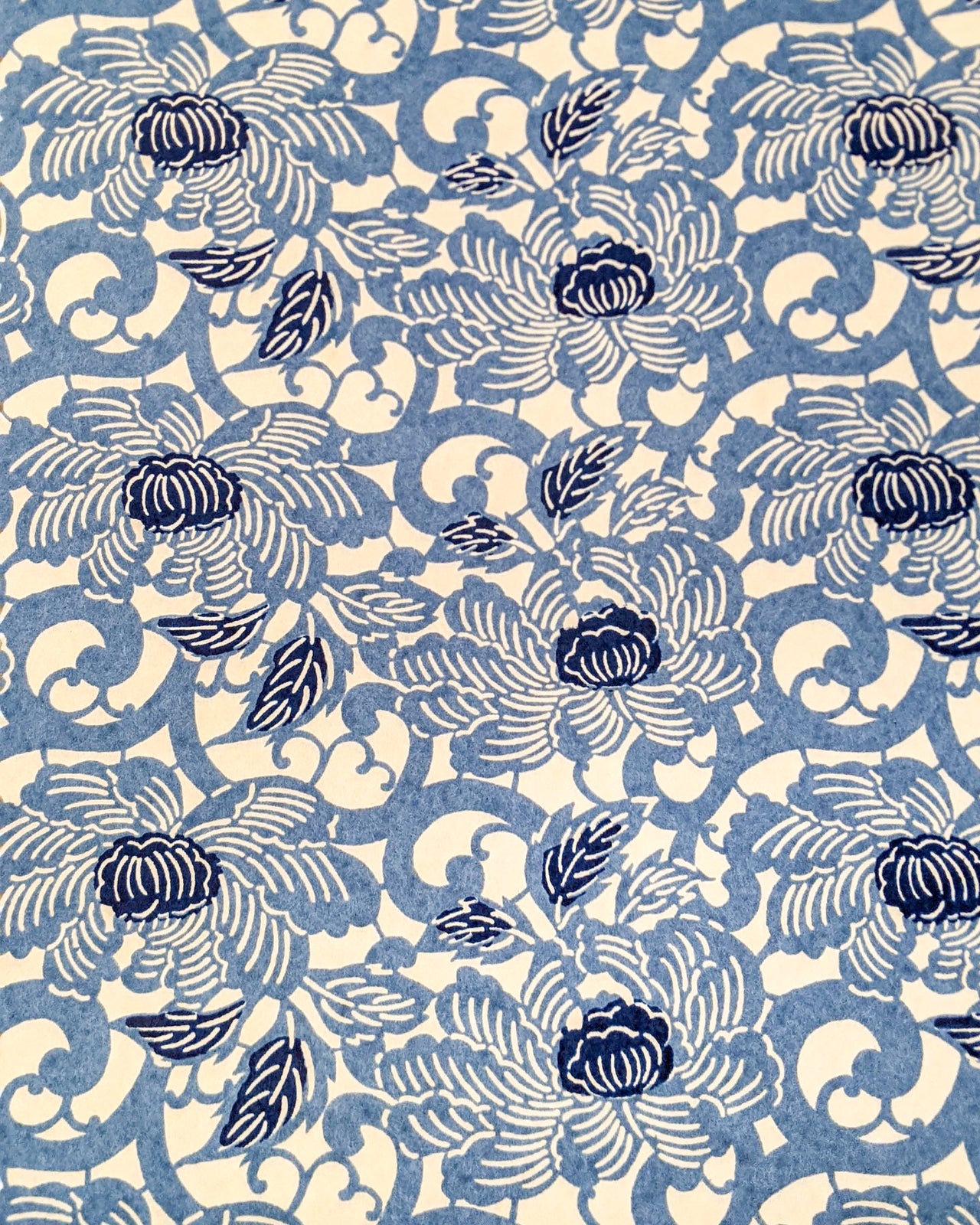 Japanese chiyogami paper featuring large blue peonies on a cream background.