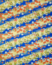 Japanese chiyogami paper featuring red and white maple leaves and traditional motifs on a blue and gold background with metallic gold details.