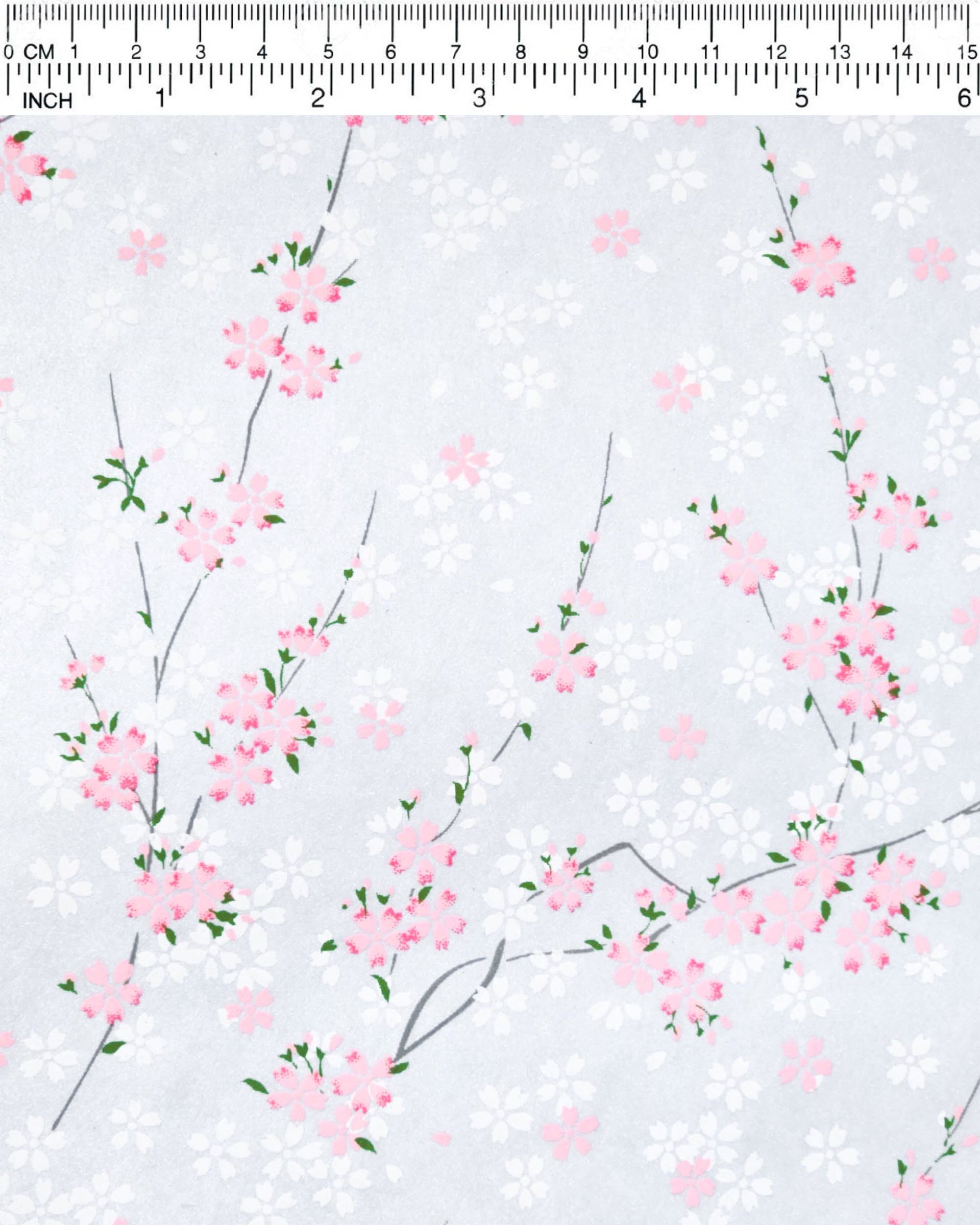 Japanese chiyogami paper featuring pink and white cherry blossoms on a pearlescent pale blue gray background.