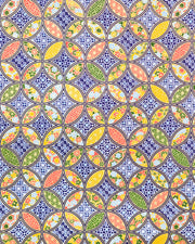 Japanese chiyogami paper featuring an orange, yellow, and green shippo design filled with assorted floral and geometric designs on a dark blue background with metallic gold details. The centers of the shippos features assorted white floral outlines.
