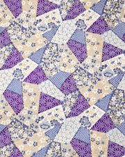 Japanese chiyogami paper featuring blue, beige, white, and purple patches embedded assorted geometric and floral designs with metallic gold details.