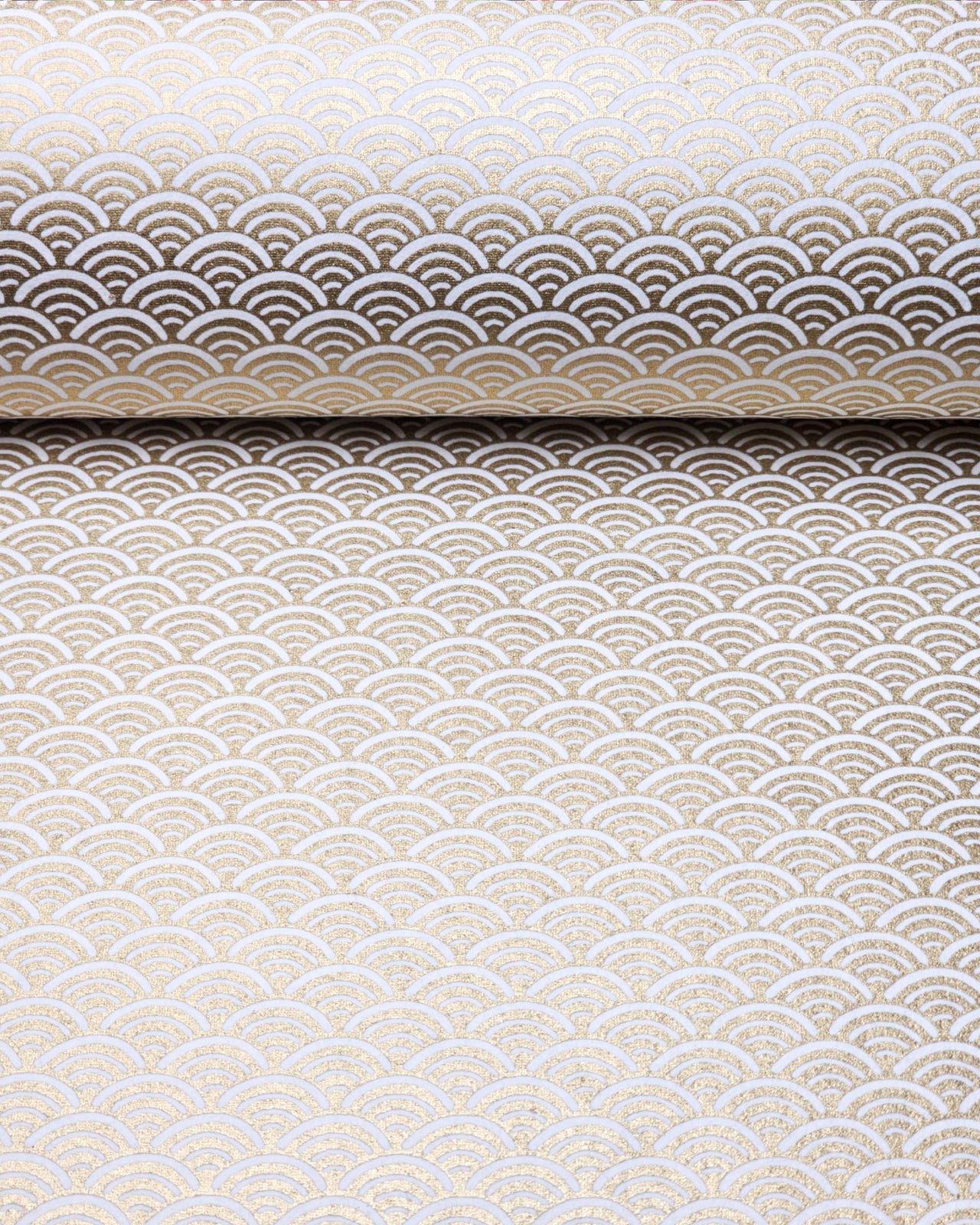 Japanese chiyogami paper featuring a traditional white and metallic gold seigaiha (wave crests) pattern.