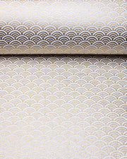 Japanese chiyogami paper featuring a traditional white and metallic gold seigaiha (wave crests) pattern.