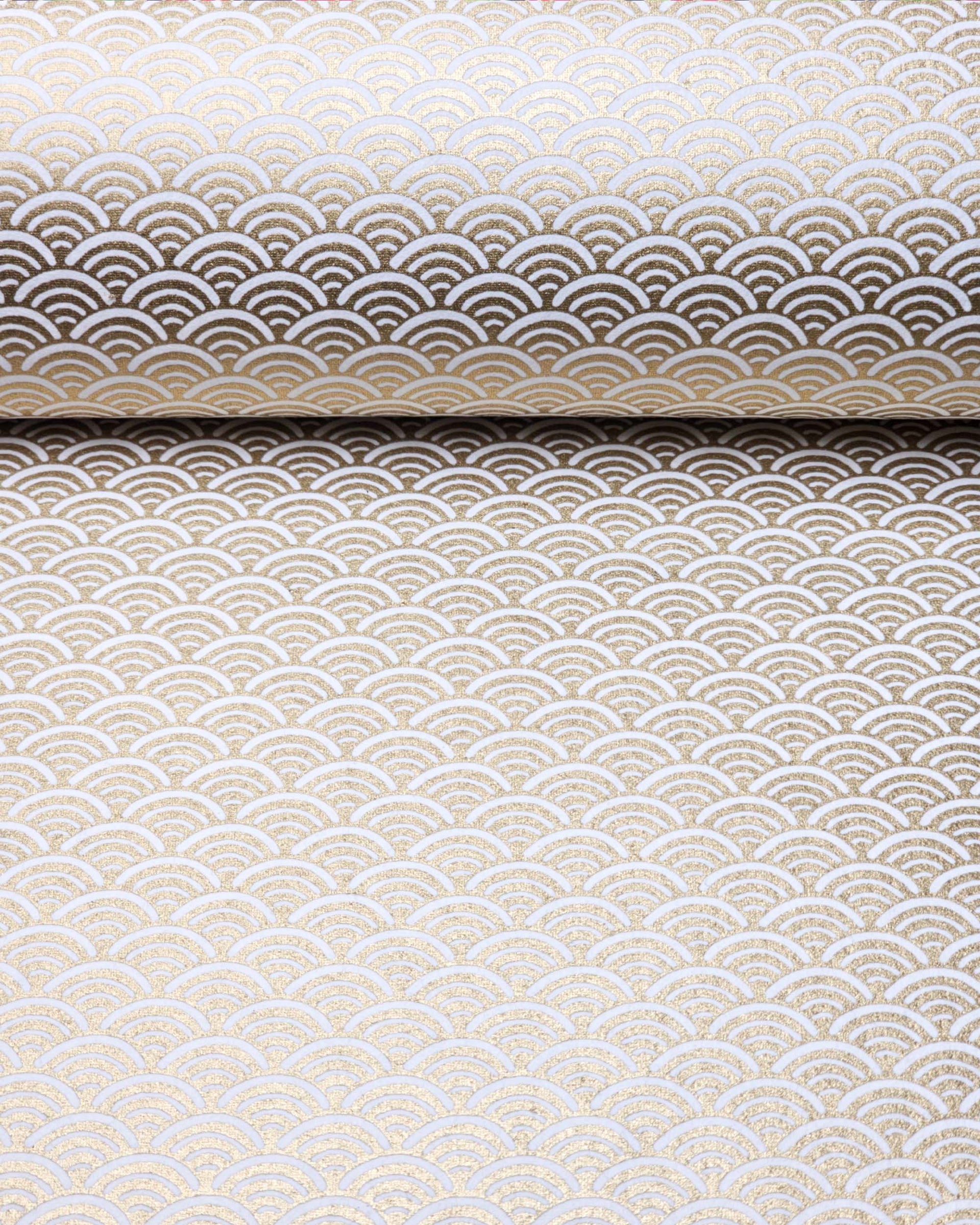 Japanese chiyogami paper featuring a traditional white and metallic gold seigaiha (wave crests) pattern.