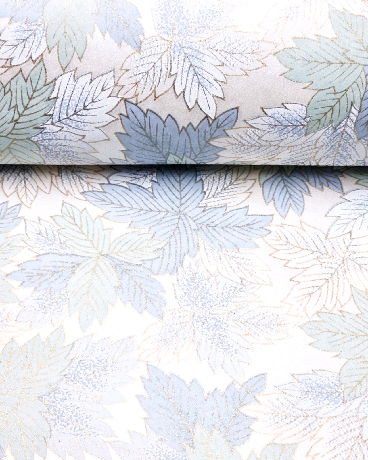Japanese chiyogami paper featuring large blue, light mint green, and white leaves on a pearlescent white background with metallic gold details.