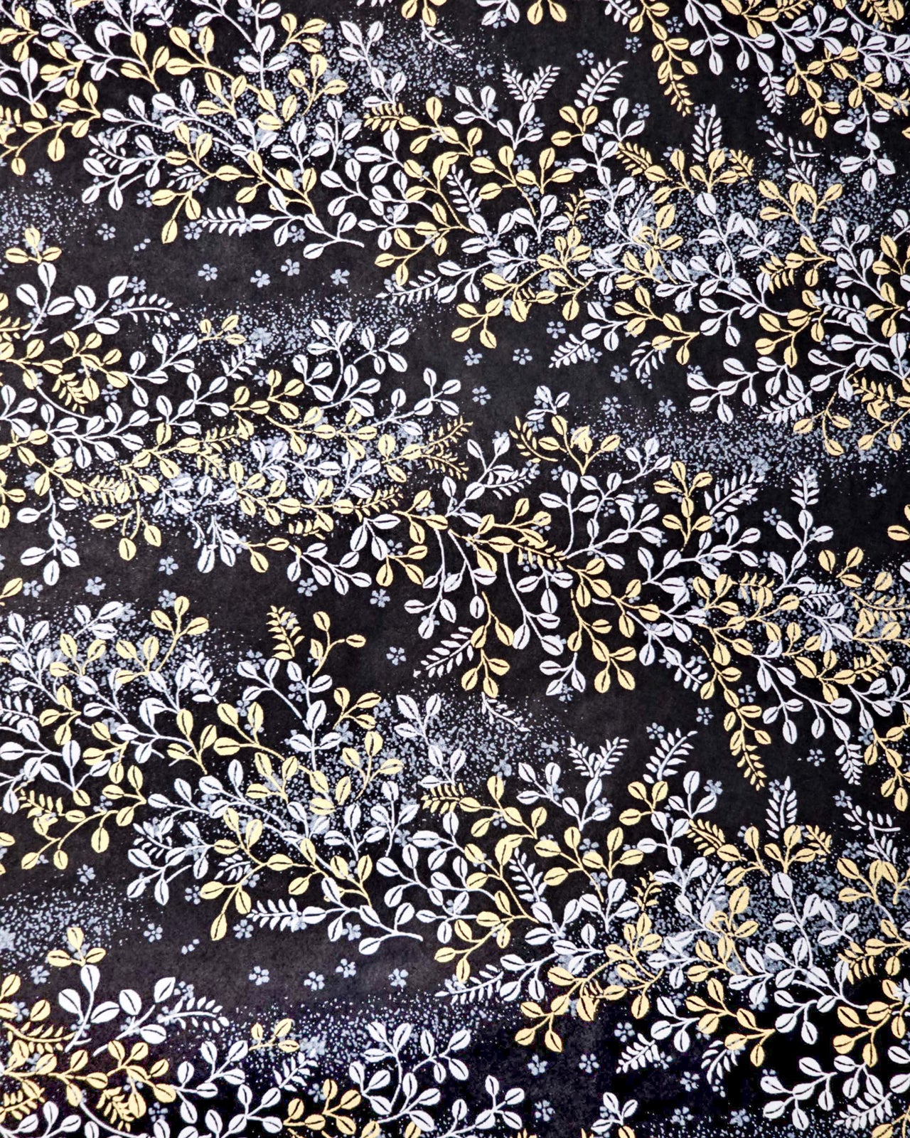 Japanese chiyogami paper featuring metallic gold and silver hagi (bush clover) on a black background.