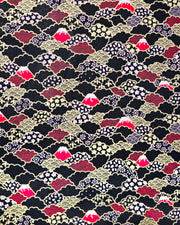 Japanese chiyogami paper featuring red Mt Fuji and gold clouds filled with assorted gold and pink geometric and flower designs on a black background.