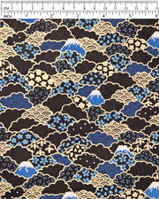 Japanese chiyogami paper featuring blue Mt Fuji and gold clouds filled with assorted gold and blue geometric and flower designs on a black background.