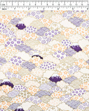 Japanese chiyogami paper featuring dark blue Mt Fuji and gold clouds filled with assorted gold, orange, and purple geometric and flower designs on a white background.