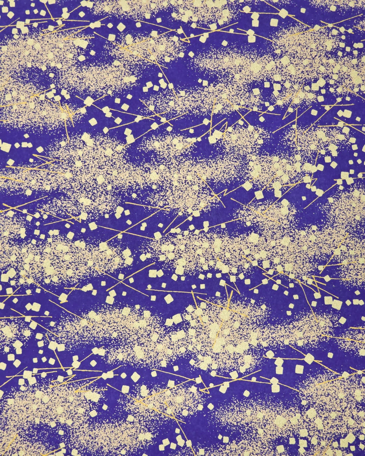 Japanese chiyogami paper featuring scattered metallic gold geometric shapes and fine gold lines on a blue background.