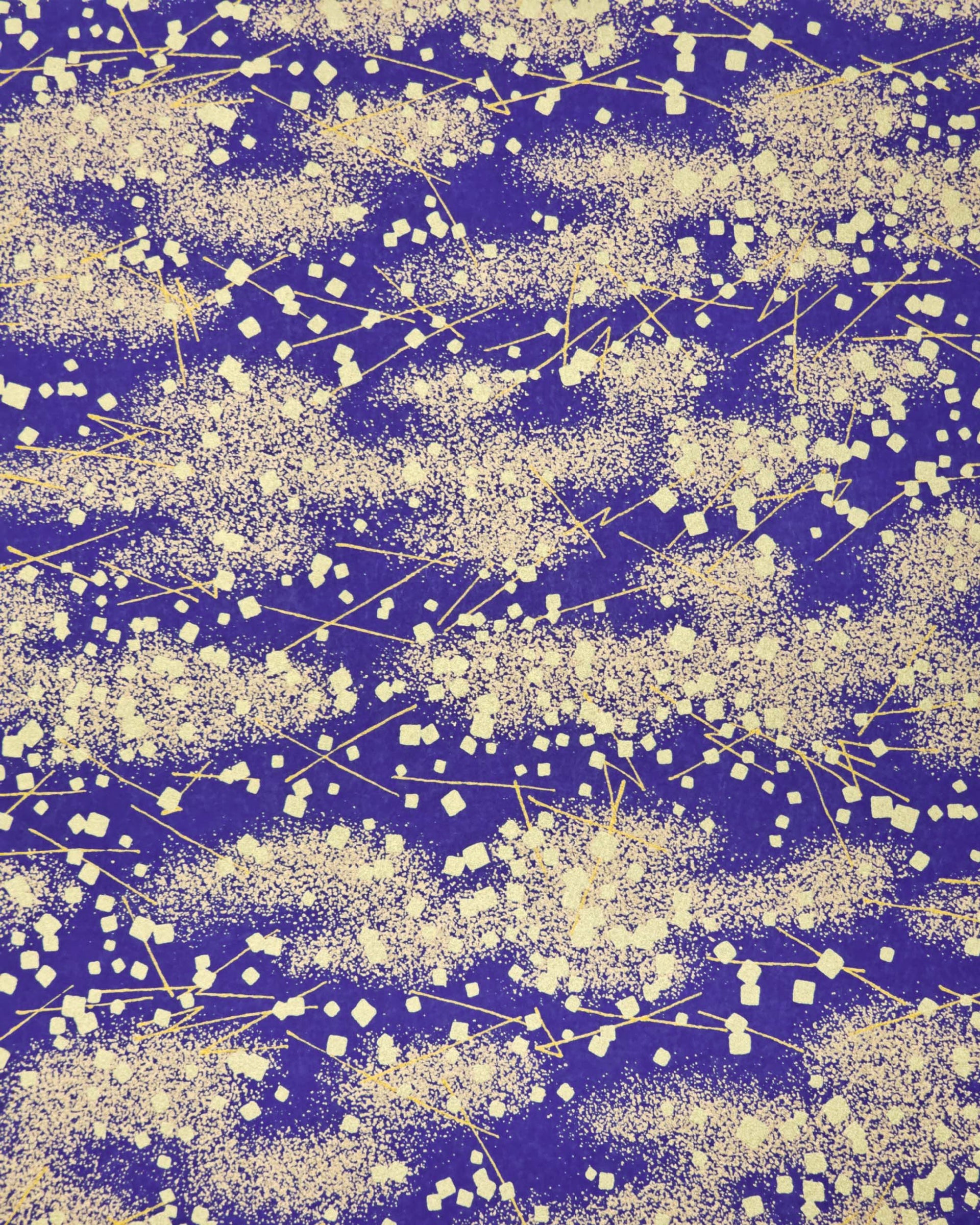 Japanese chiyogami paper featuring scattered metallic gold geometric shapes and fine gold lines on a blue background.