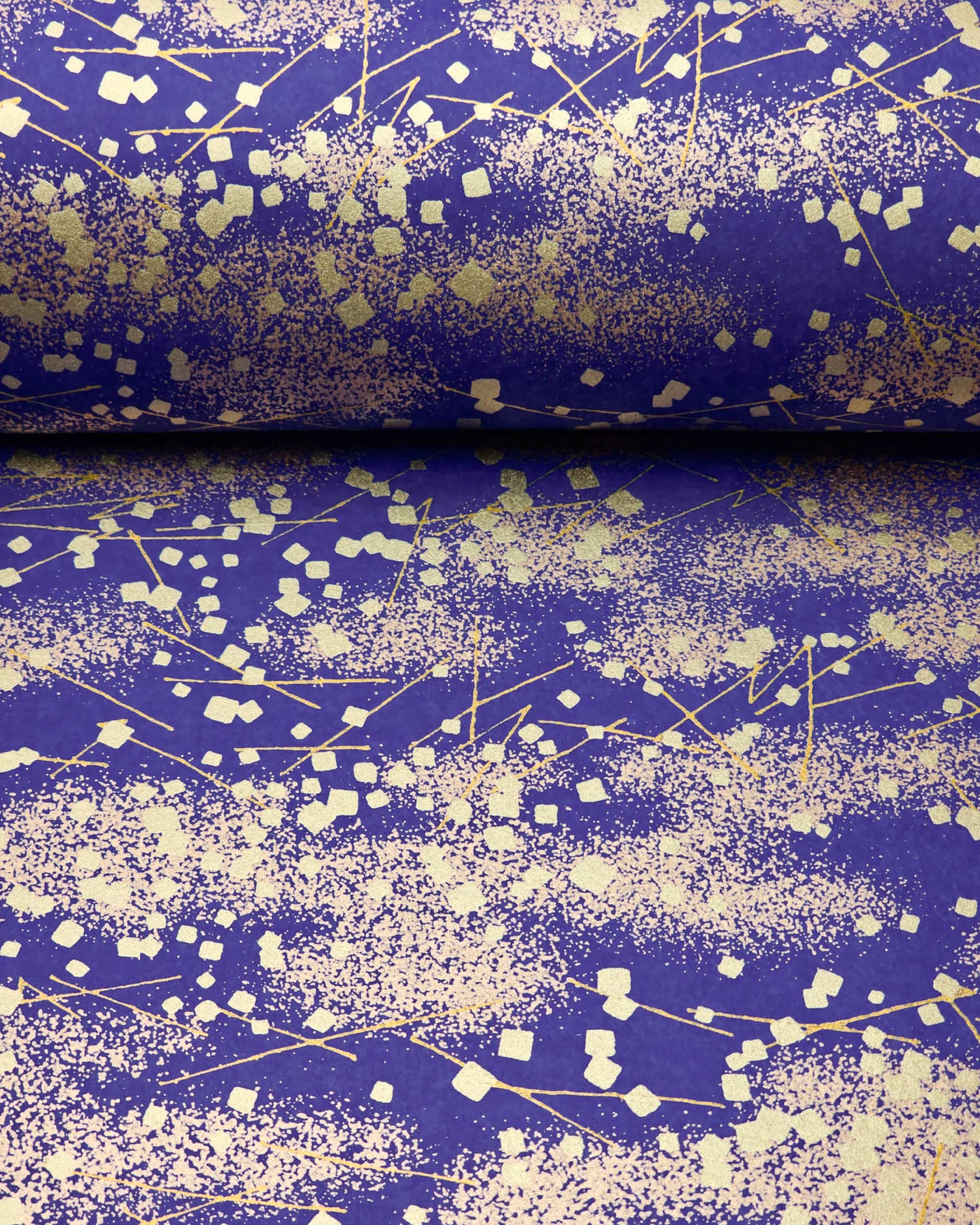 Japanese chiyogami paper featuring scattered metallic gold geometric shapes and fine gold lines on a blue background.