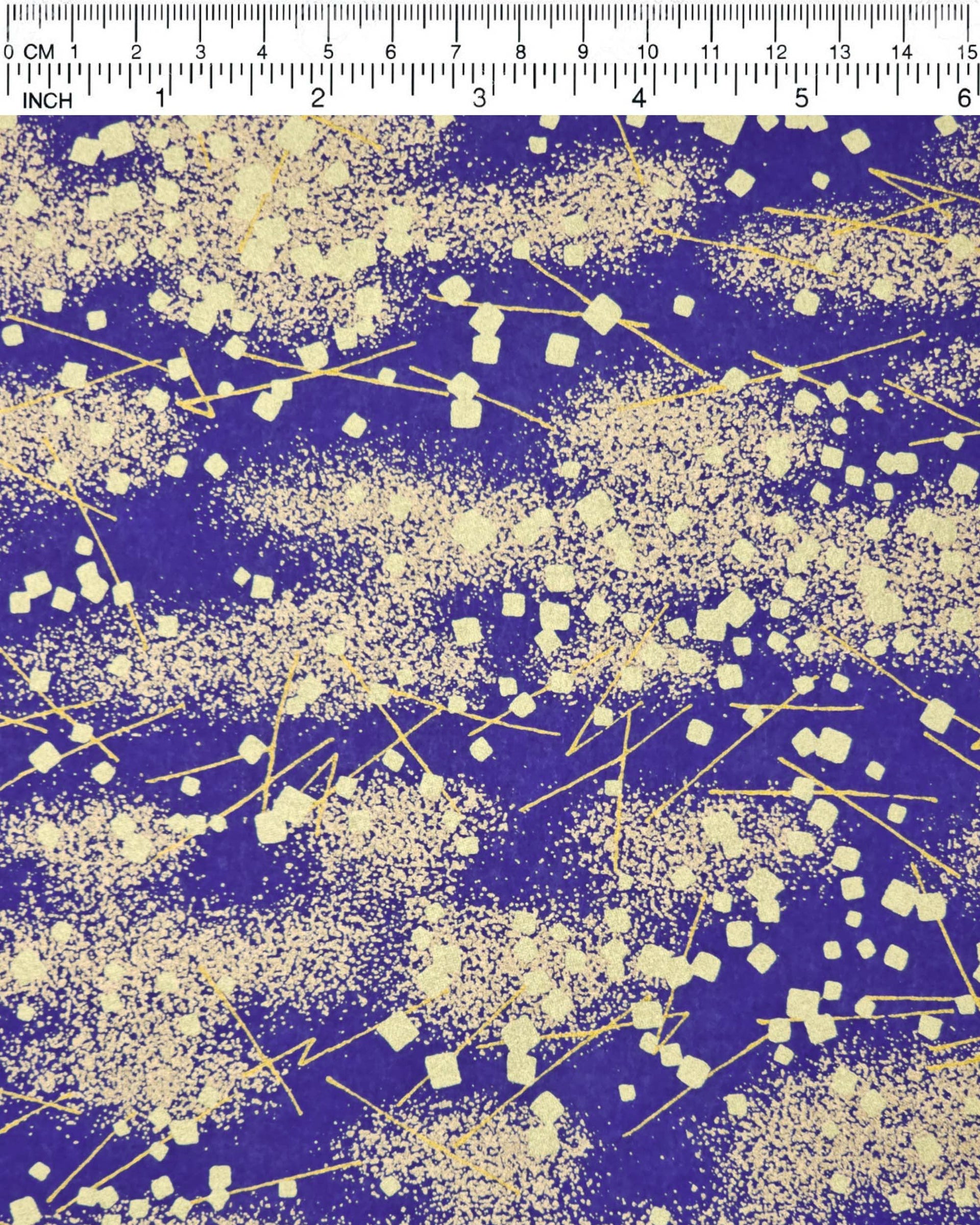 Japanese chiyogami paper featuring scattered metallic gold geometric shapes and fine gold lines on a blue background.
