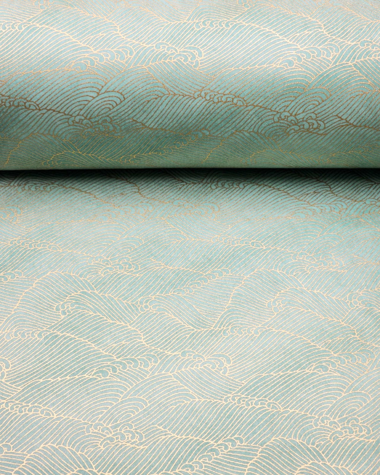 Japanese chiyogami paper featuring small metallic gold waves (aranami) on a gradient green background.