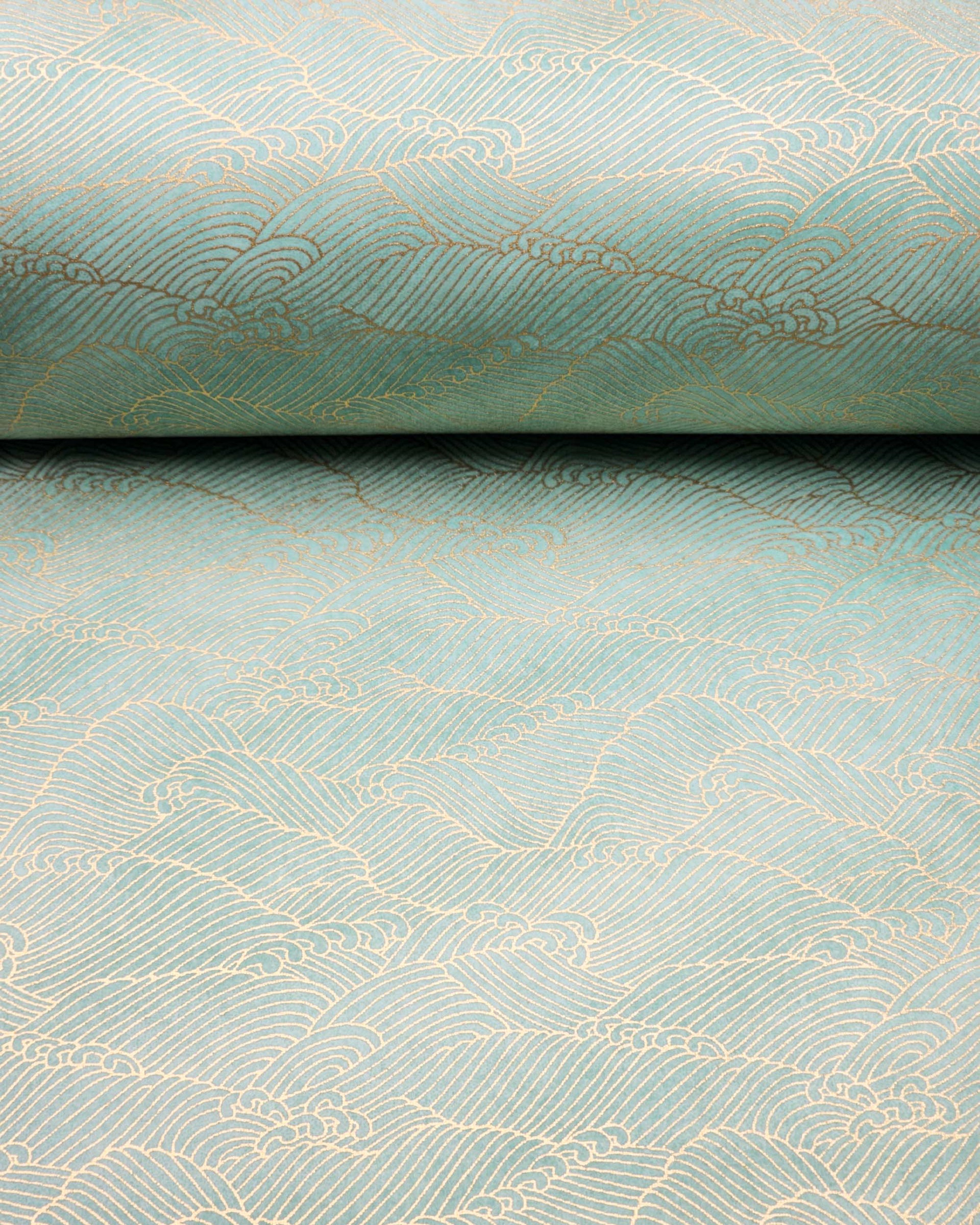 Japanese chiyogami paper featuring small metallic gold waves (aranami) on a gradient green background.