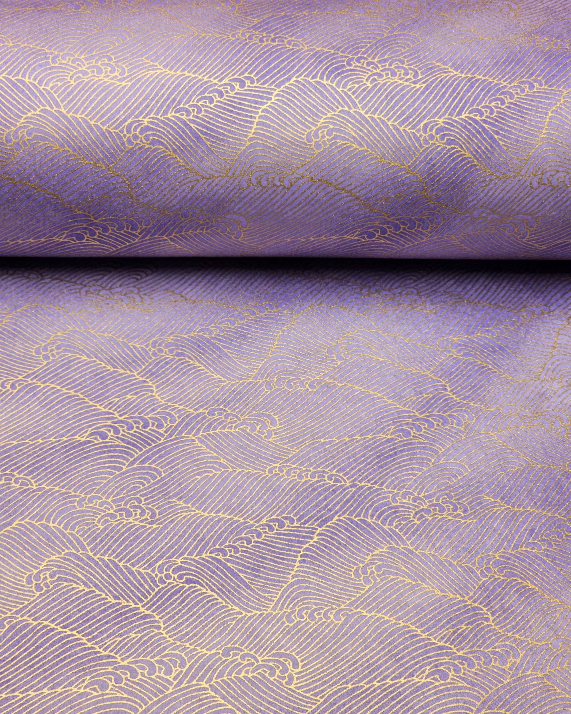 Japanese chiyogami paper featuring small metallic gold waves (aranami) on a gradient purple background.
