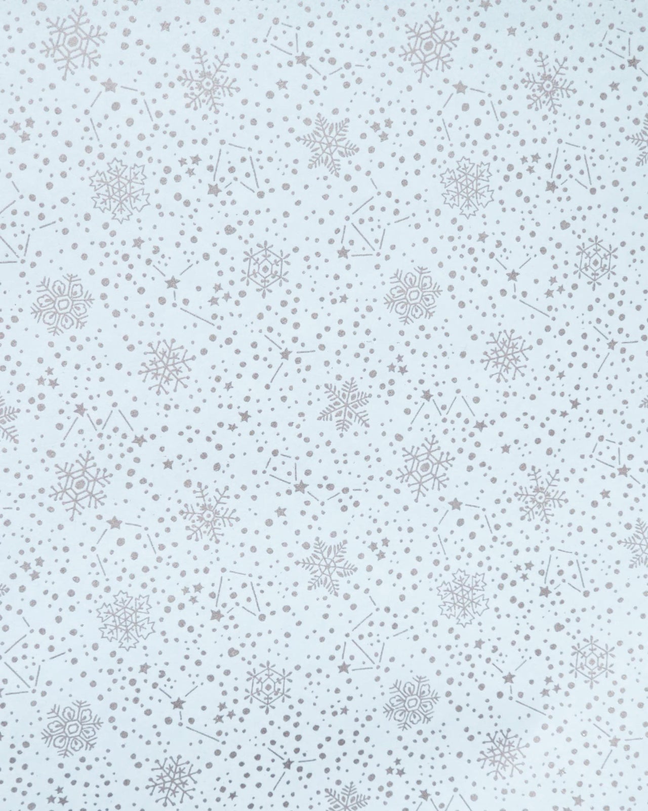 Japanese chiyogami paper featuring assorted metallic silver snowflakes and star constellations on a light blue background.