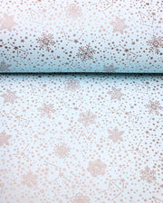 Japanese chiyogami paper featuring assorted metallic silver snowflakes and star constellations on a light blue background.