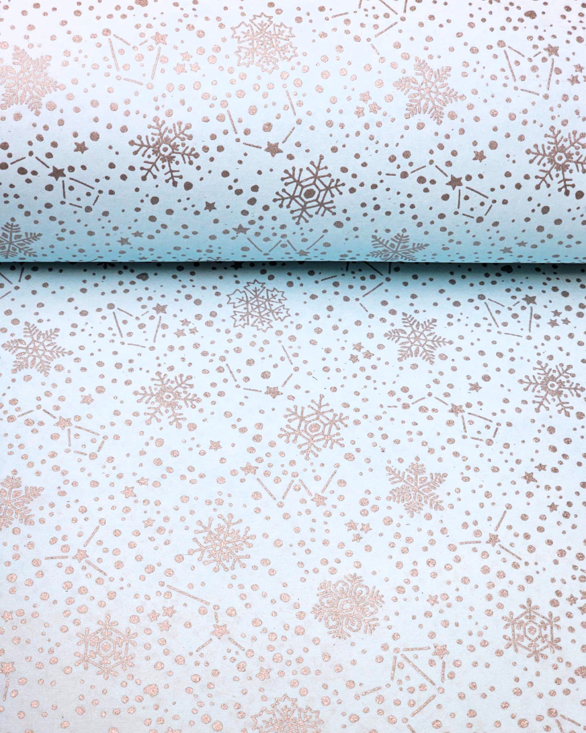 Japanese chiyogami paper featuring assorted metallic silver snowflakes and star constellations on a light blue background.