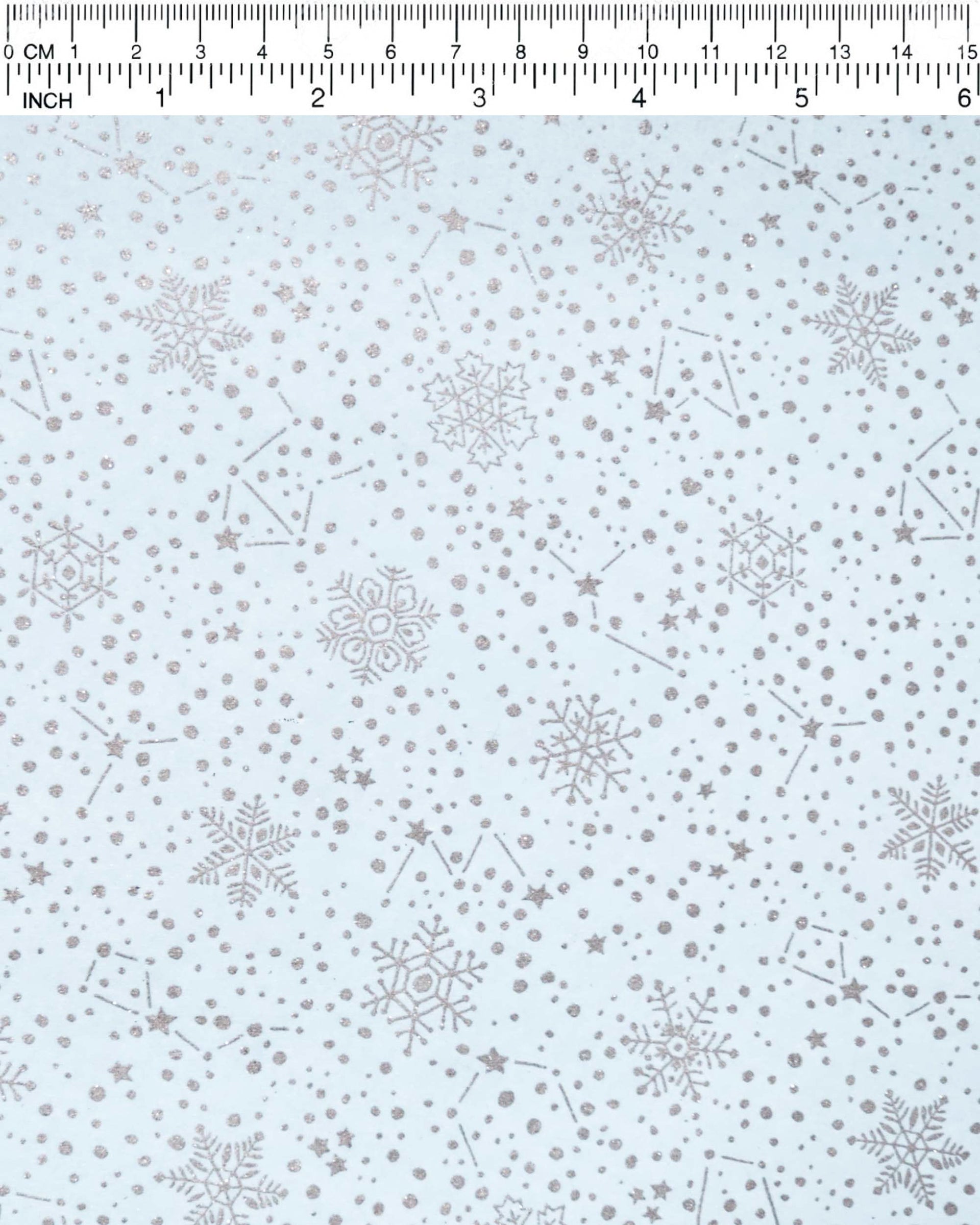 Japanese chiyogami paper featuring assorted metallic silver snowflakes and star constellations on a light blue background.
