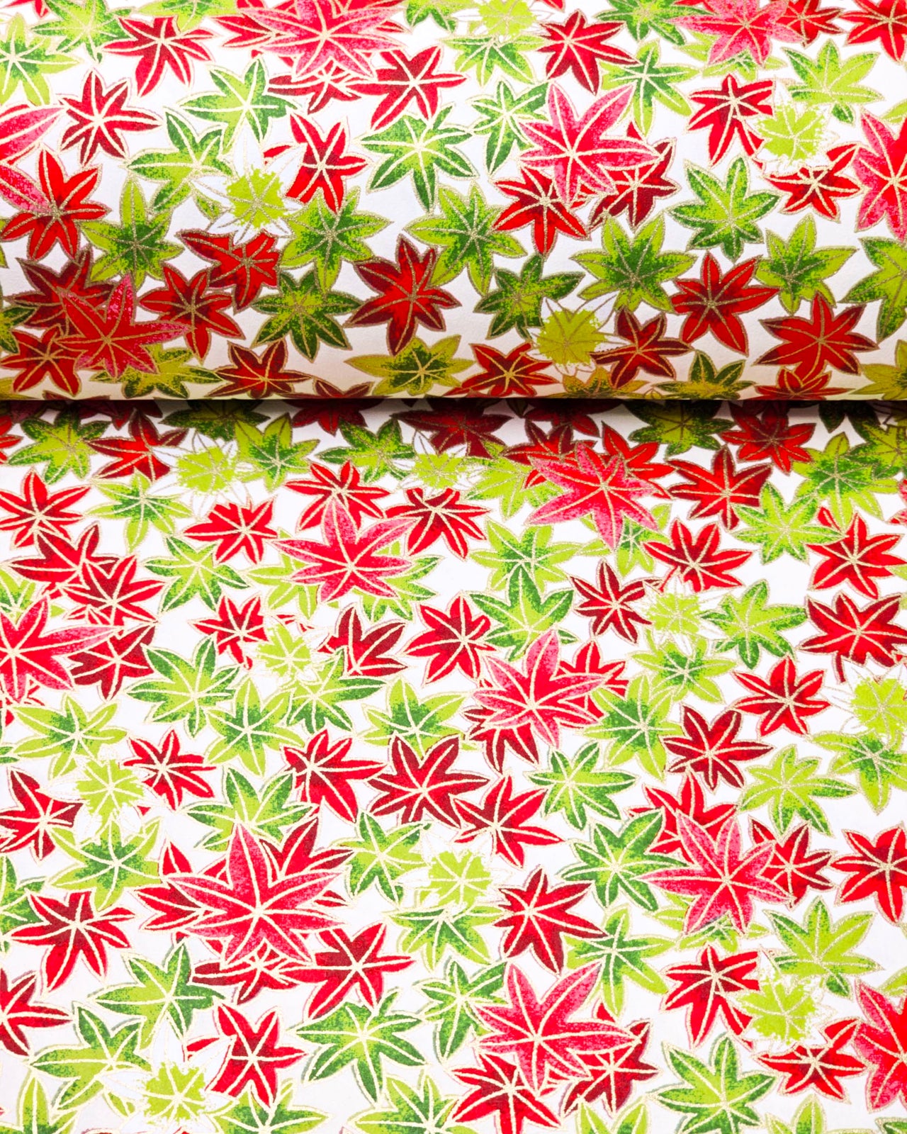 Japanese chiyogami paper featuring red, green, and white momiji (maples leaves) on a white background with metallic gold details.