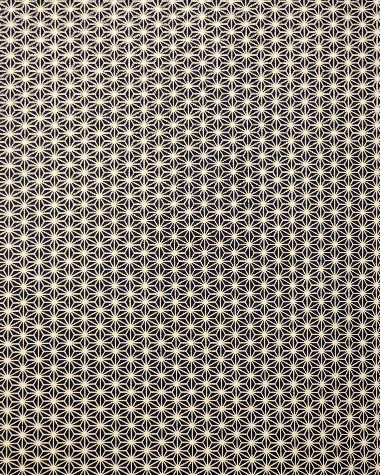 Japanese chiyogami paper featuring a small traditional gold asanoha (hemp leaf) pattern on a black background.