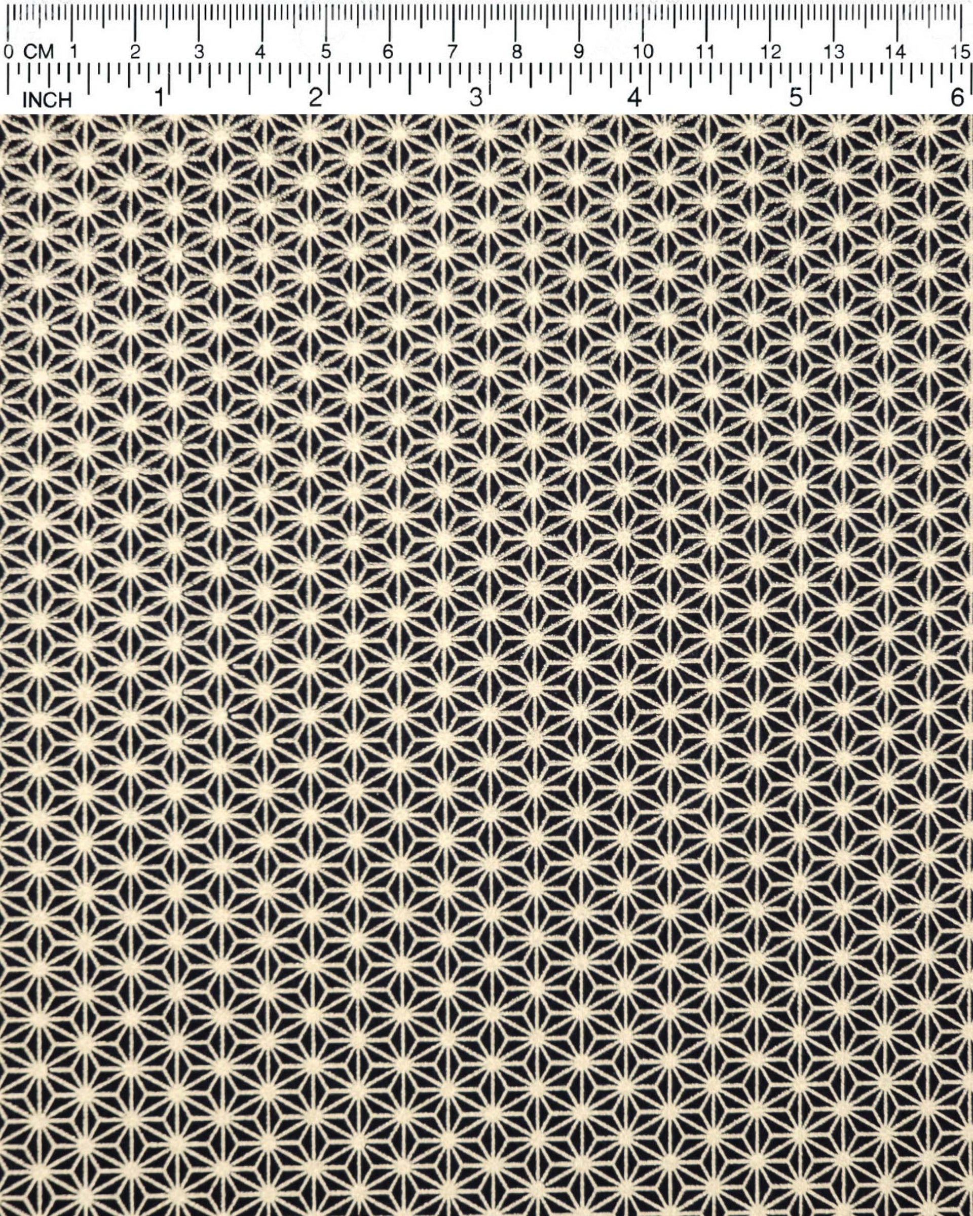 Japanese chiyogami paper featuring a small traditional gold asanoha (hemp leaf) pattern on a black background.