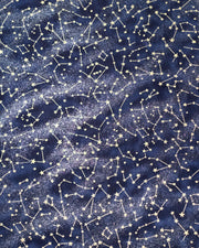 Japanese chiyogami paper featuring metallic gold stars and constellations scattered across a dark blue gradient background with shimmering metallic silver stardust.