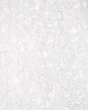 Japanese chiyogami paper featuring white flying cranes and plum and cherry blossoms on a pearlescent white background with metallic silver accents that create a fine glitter-like effect.