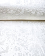 Japanese chiyogami paper featuring white flying cranes and plum and cherry blossoms on a pearlescent white background with metallic silver accents that create a fine glitter-like effect.