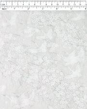 Japanese chiyogami paper featuring white flying cranes and plum and cherry blossoms on a pearlescent white background with metallic silver accents that create a fine glitter-like effect.