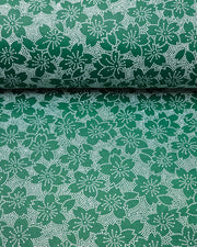 Japanese chiyogami paper featuring white pointillistic cherry blossoms on a dark green background.