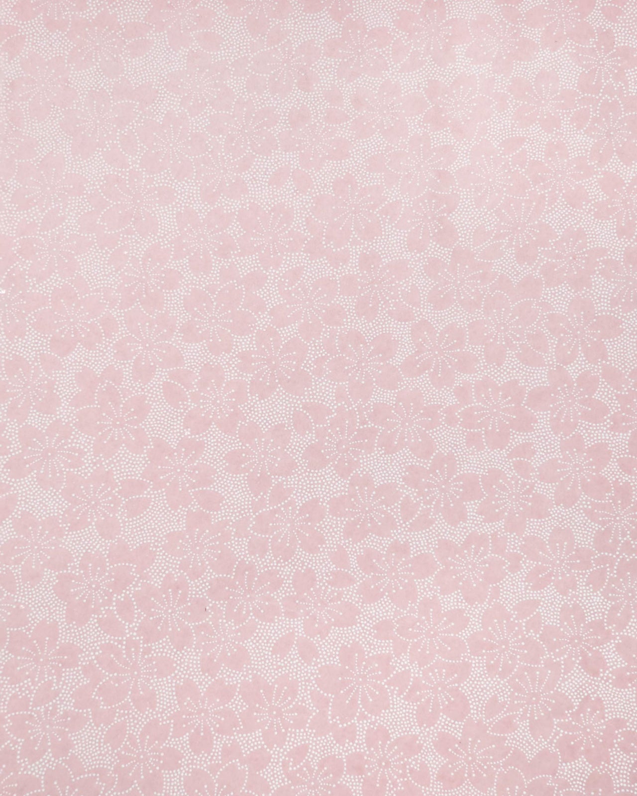 Japanese chiyogami paper featuring white pointillistic cherry blossoms on a dusty blush pink background.