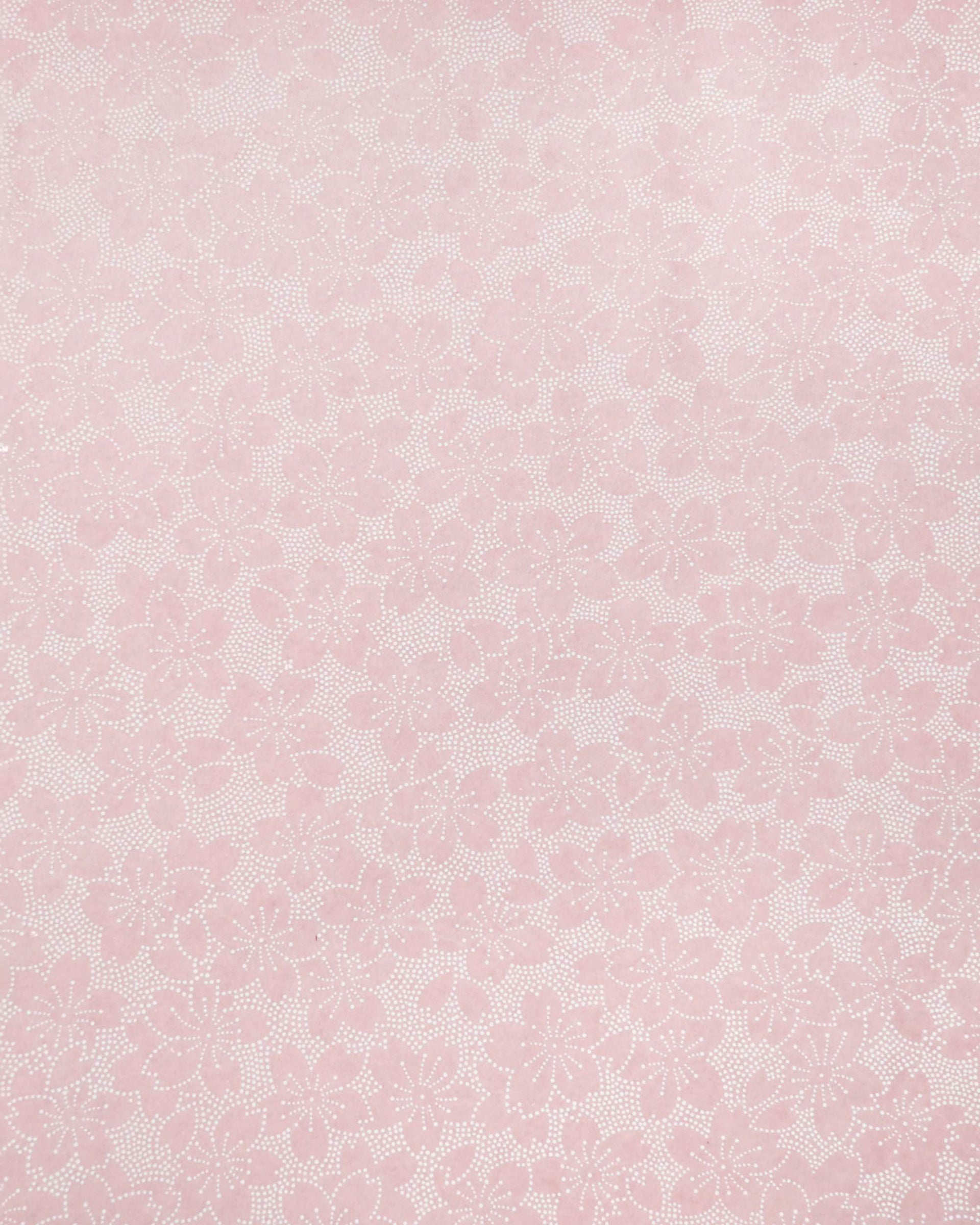 Japanese chiyogami paper featuring white pointillistic cherry blossoms on a dusty blush pink background.