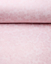 Japanese chiyogami paper featuring white pointillistic cherry blossoms on a dusty blush pink background.