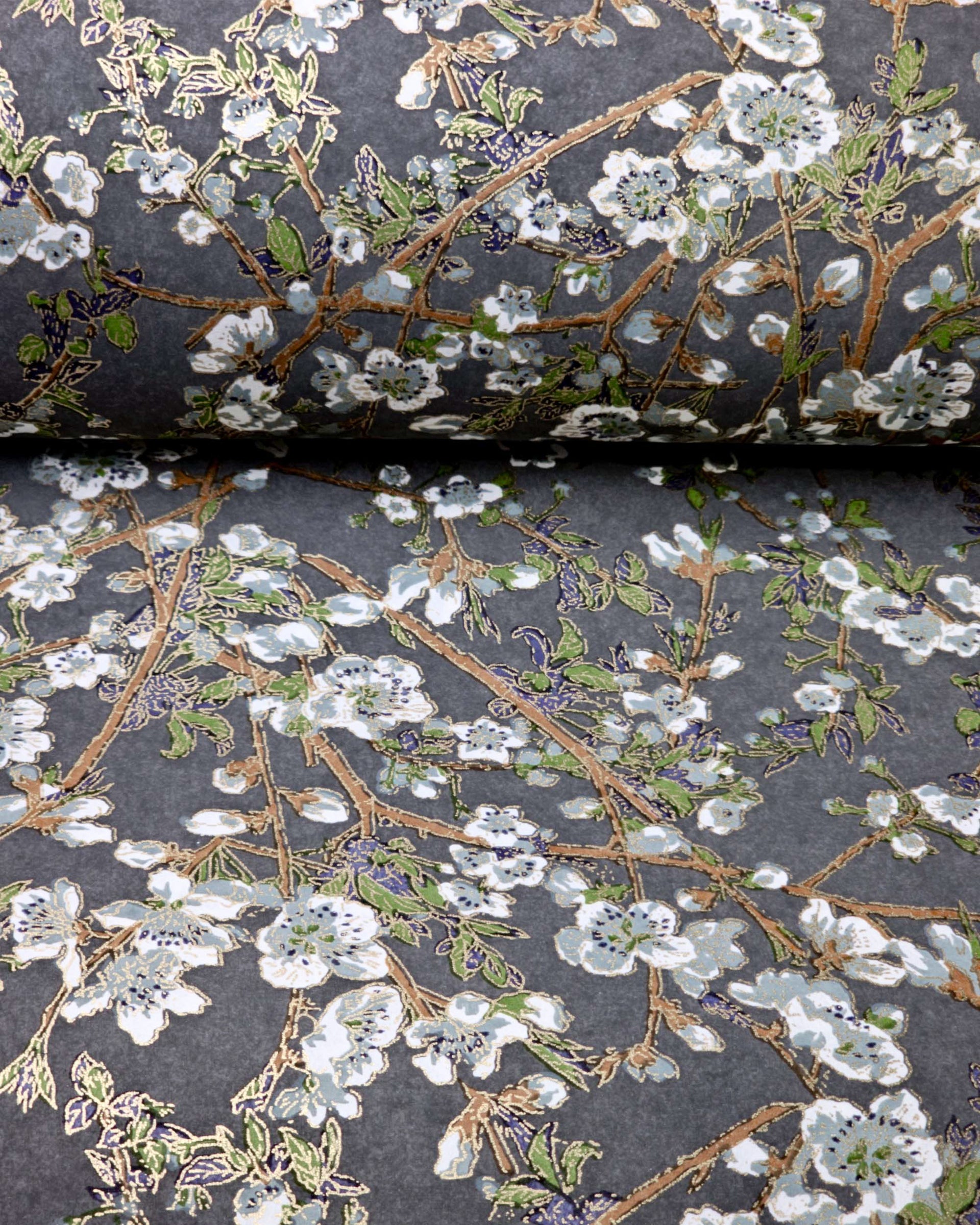 Japanese chiyogami paper featuring gray and white detailed plum blossoms with brown branches and green leaves on a dark gray background with metallic gold details.