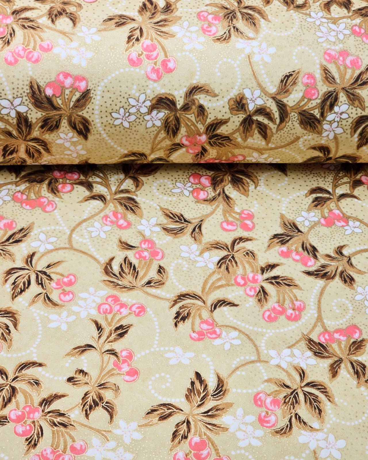 Japanese chiyogami paper featuring clusters of pink cherry fruit with white flowers and brown leaves on a beige background with metallic gold details.