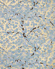Japanese chiyogami paper featuring light blue and white plum blossom trees with dark brown branches on a gold background with metallic gold details.