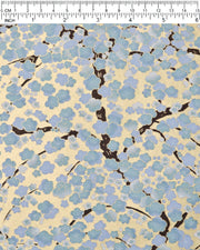 Japanese chiyogami paper featuring light blue and white plum blossom trees with dark brown branches on a gold background with metallic gold details.