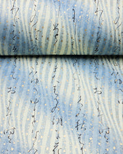 Japanese chiyogami paper featuring black Japanese calligraphy on a vertically swirling blue-gray and cream gradient background with metallic gold details.